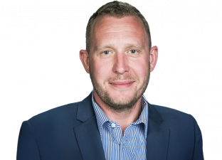 Man wearing blue collared shirt with suit jacket