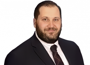 Man with beard wearing a suit and tie